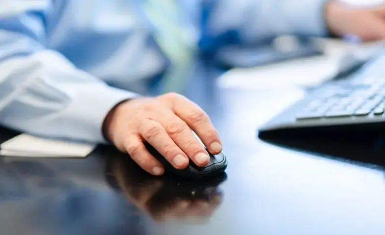 Close-up of a professional using a computer mouse, representing seamless workflow with top proposal software.